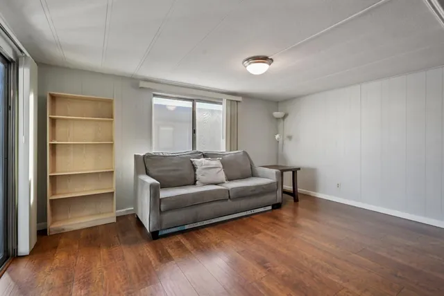 a kitchen with a dining table chairs and refrigerator
