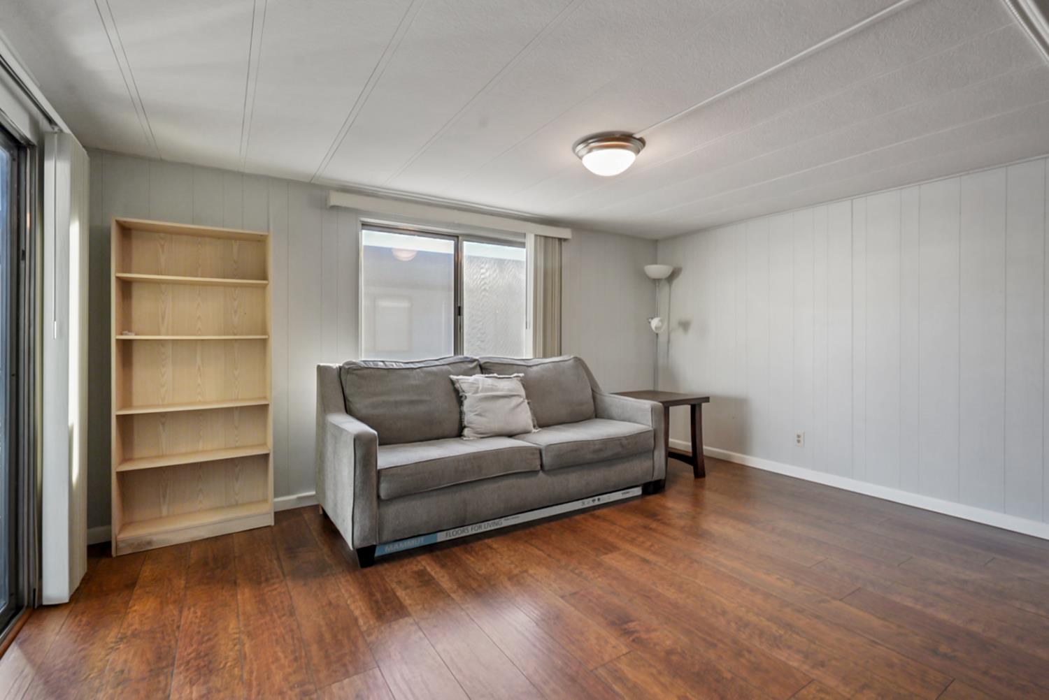 1400 North Tully Road, Unit 137 Turlock, CA 95380 - Photo 8 of 37 a living room with furniture and a wooden floor