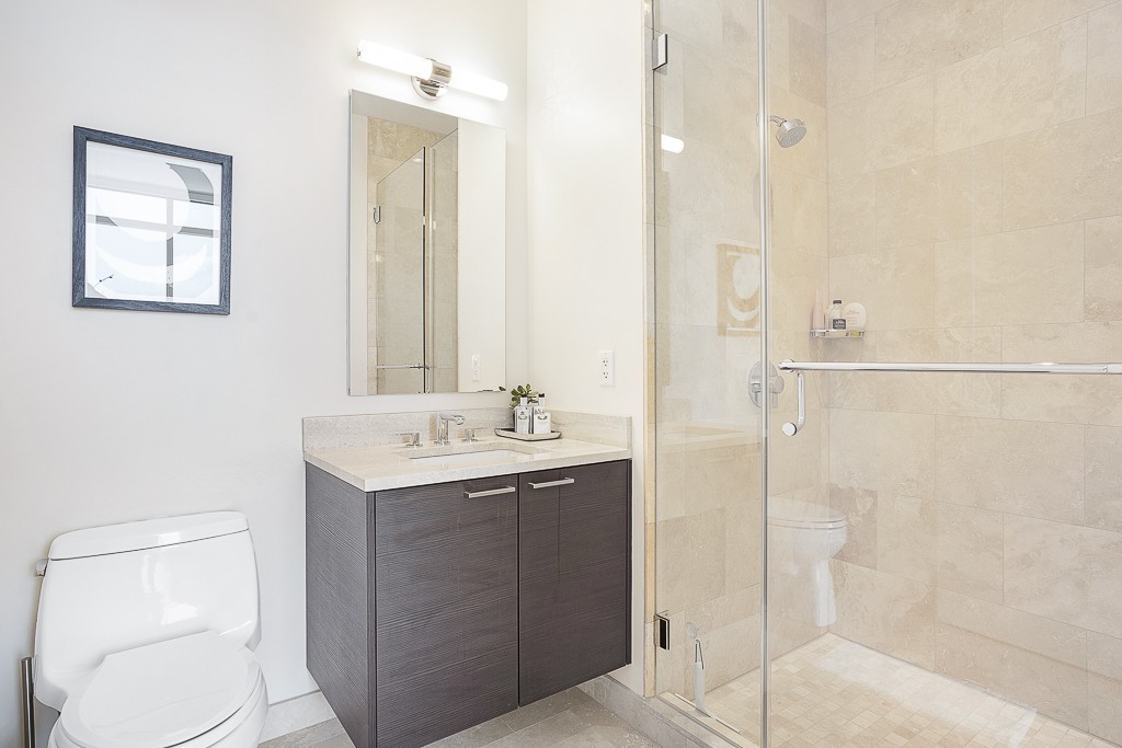 1 Franklin Street, Unit 3701 Boston, MA 02110 - Photo 15 of 26 a bathroom with a toilet a sink and mirror