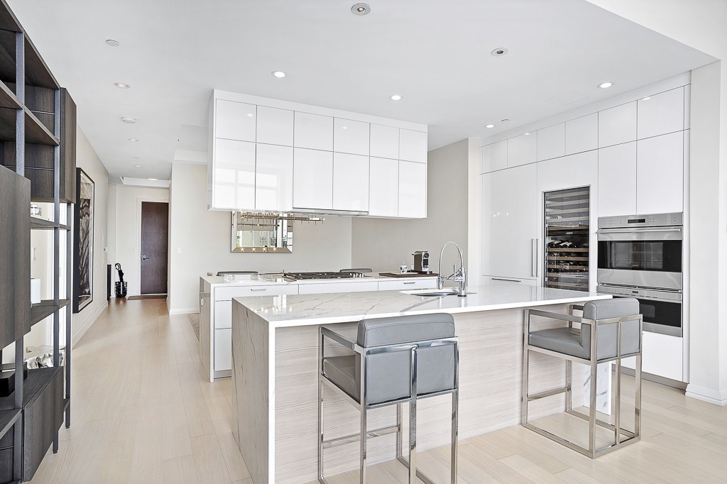 1 Franklin Street, Unit 3701 Boston, MA 02110 - Photo 5 of 26 a kitchen with a stove a sink and a refrigerator