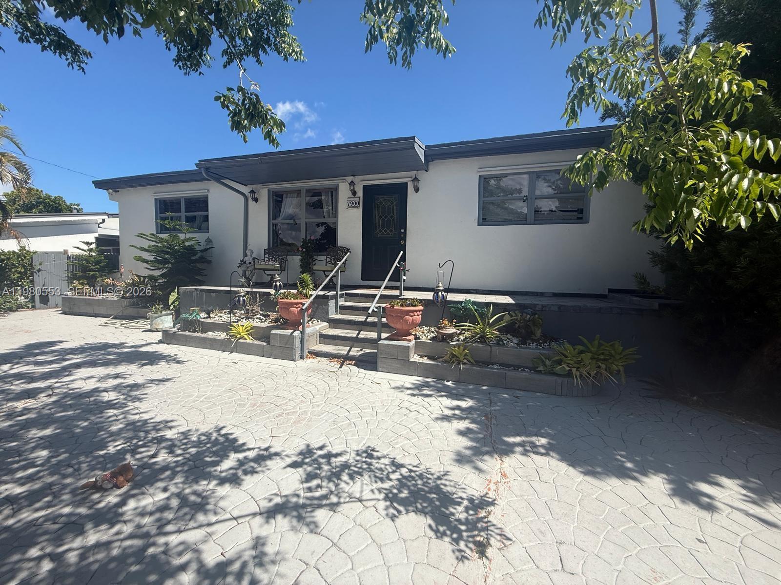 a backyard of a house with yard and outdoor seating