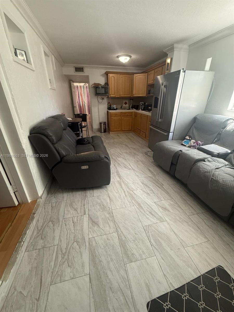 7900 Southwest 21st Terrace Miami, FL 33155 - Photo 4 of 9 a living room with furniture and kitchen view