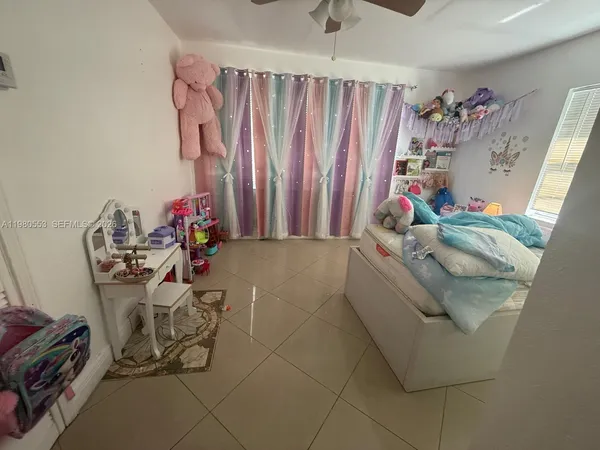 a view of a livingroom with furniture and a window