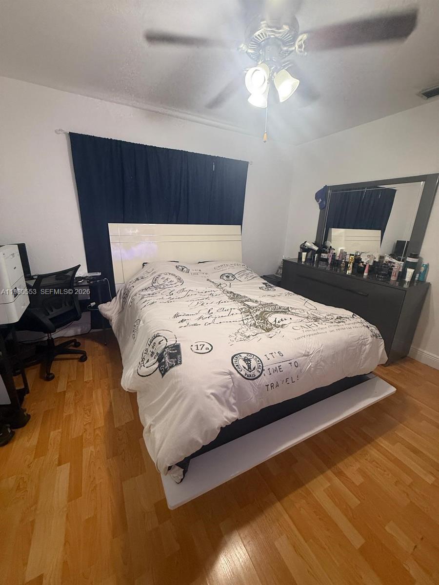 7900 Southwest 21st Terrace Miami, FL 33155 - Photo 7 of 9 a bedroom with a bed and wooden floor