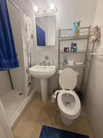 a white toilet sitting next to a bathroom sink