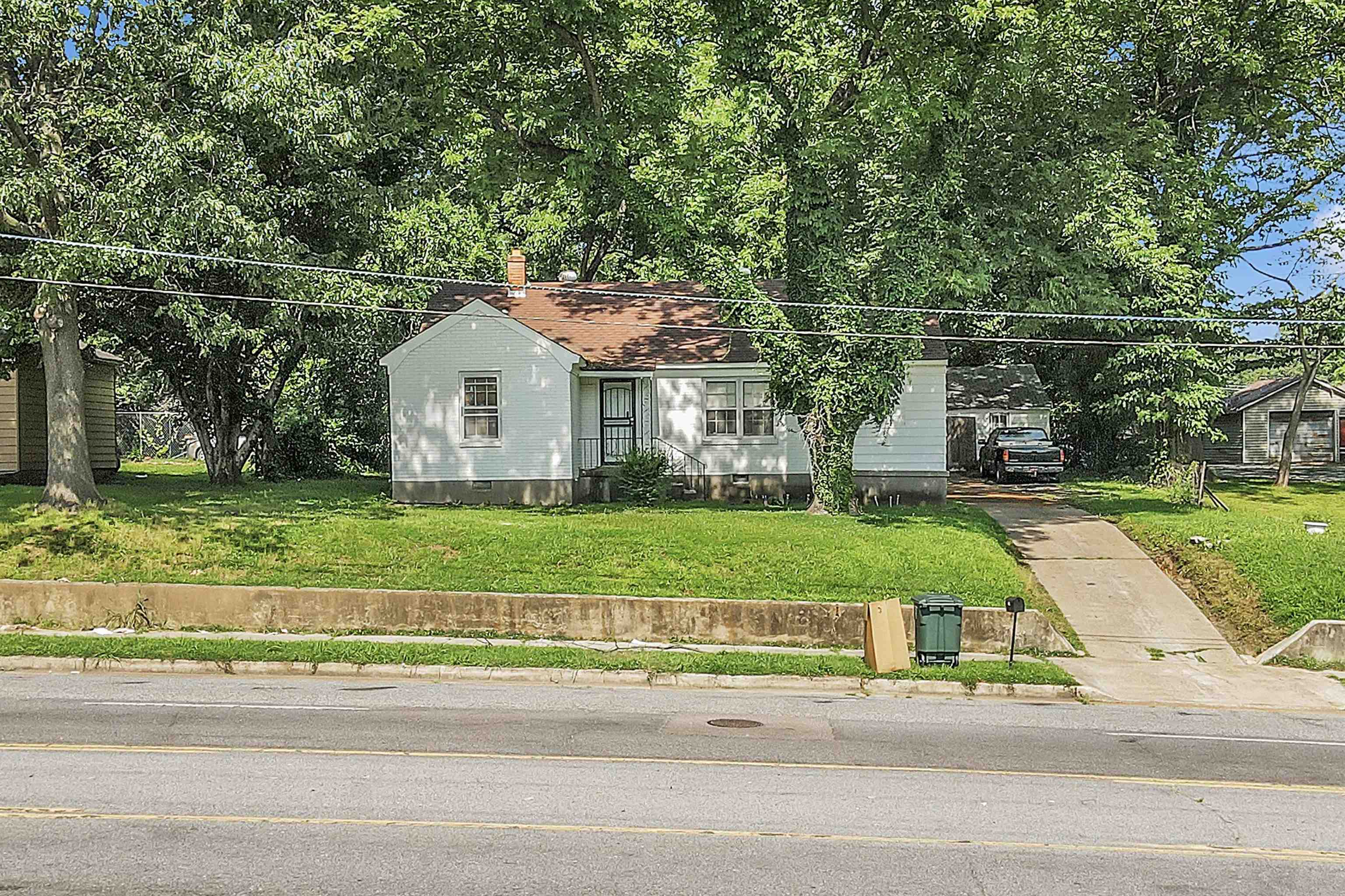 3267 Millington Road Memphis, TN 38127 - Photo 1 of 1 View of front facade with driveway, a front yard, crawl space, and a chimney