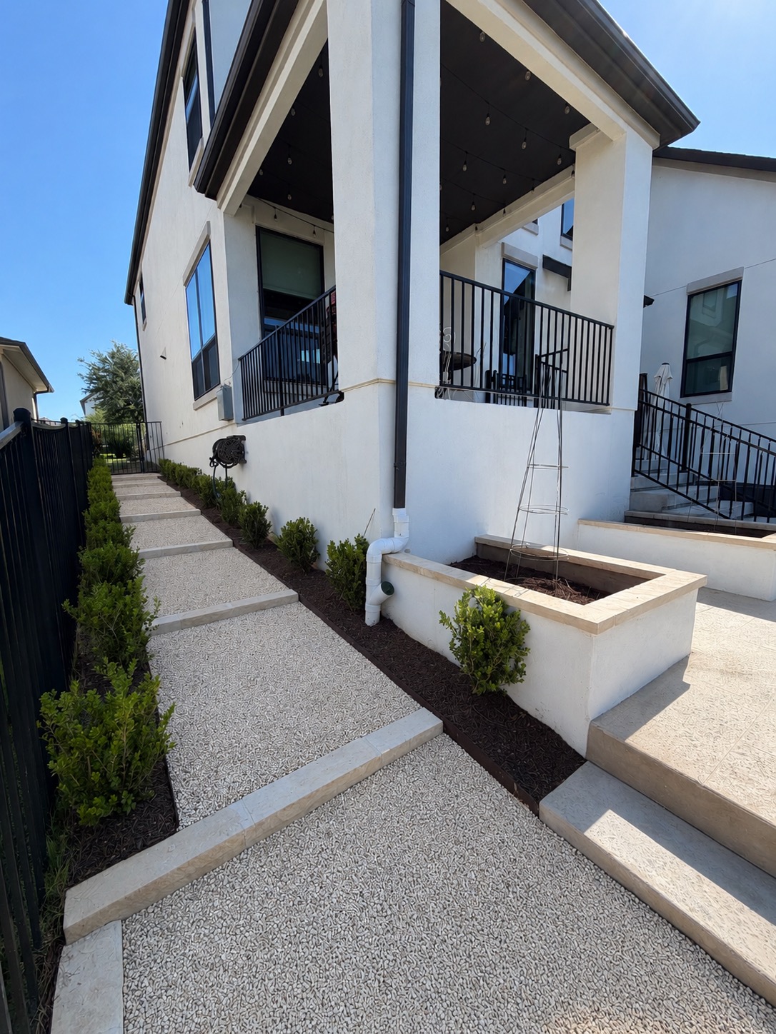 1221 Siena Sunset Road Leander, TX 78641 - Photo 37 of 39 Exterior stucco finish with black-framed windows and a covered patio featuring black railings