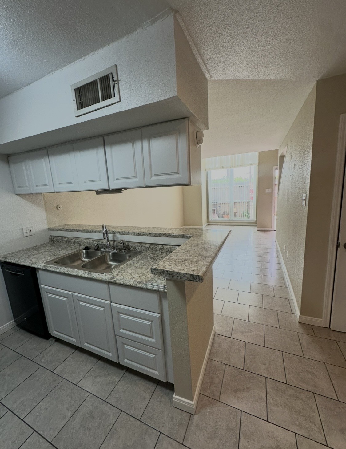 16120 Stuebner Airline Road, Unit 202 Spring, TX 77379 - Photo 4 of 12 a kitchen with granite countertop a sink and a stove
