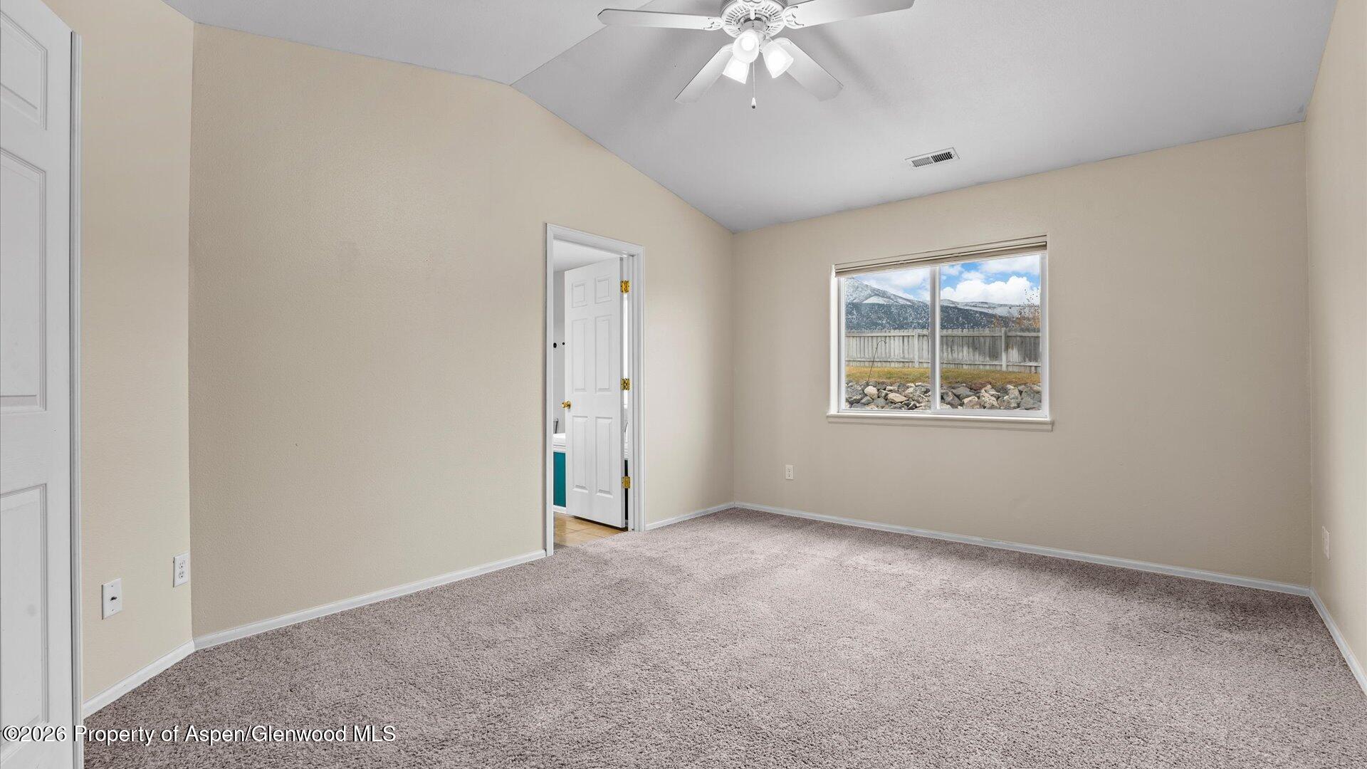 188 Cliff View Circle Parachute, CO 81635 - Photo 23 of 36 an empty room with a chandelier fan and windows