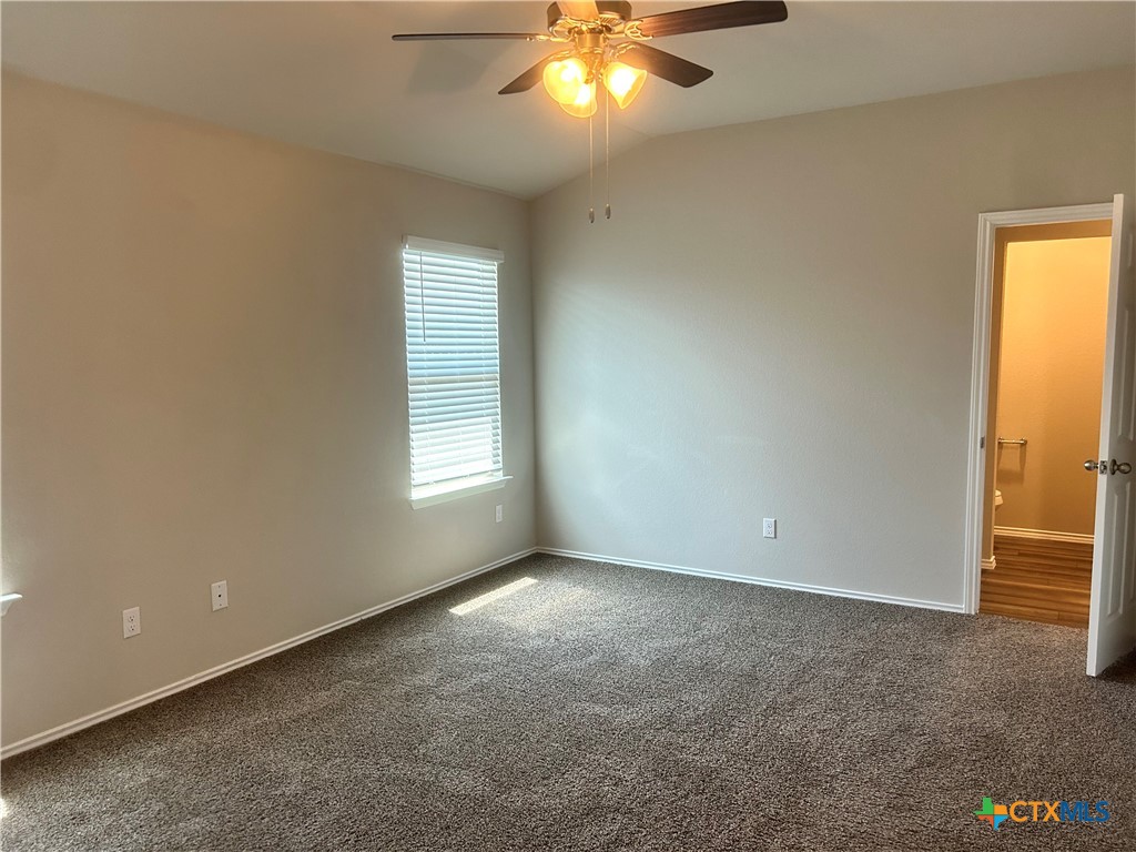 8419 Brahma Plns Road Temple, TX 76502 - Photo 8 of 17 an empty room with a window and chandelier fan