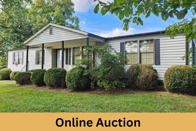 a view of an house with backyard space and garden