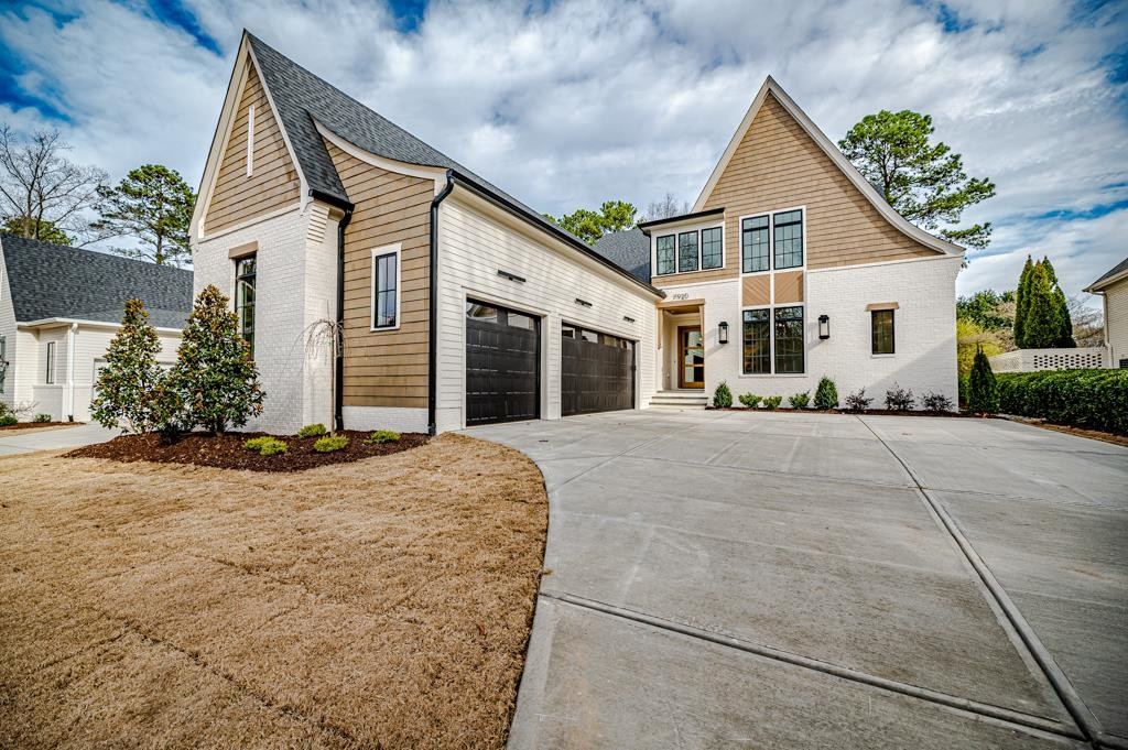 7920 Hardwick Drive Raleigh, NC 27615 - Photo 1 of 53 a front view of a house with a yard and garage