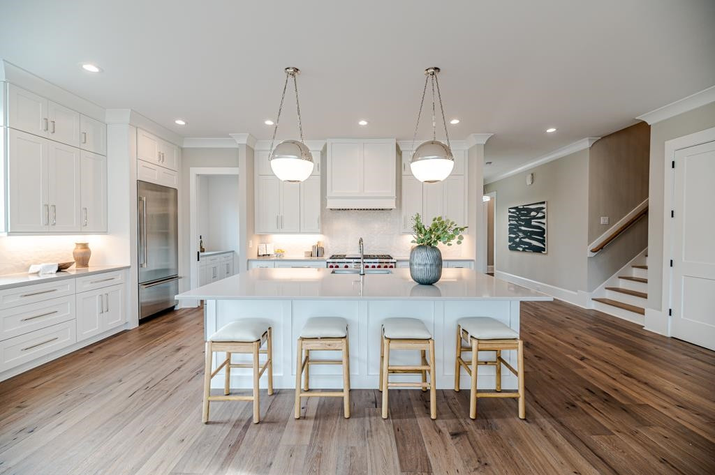 7920 Hardwick Drive Raleigh, NC 27615 - Photo 11 of 53 a kitchen with stainless steel appliances granite countertop a kitchen island hardwood floor sink and stove