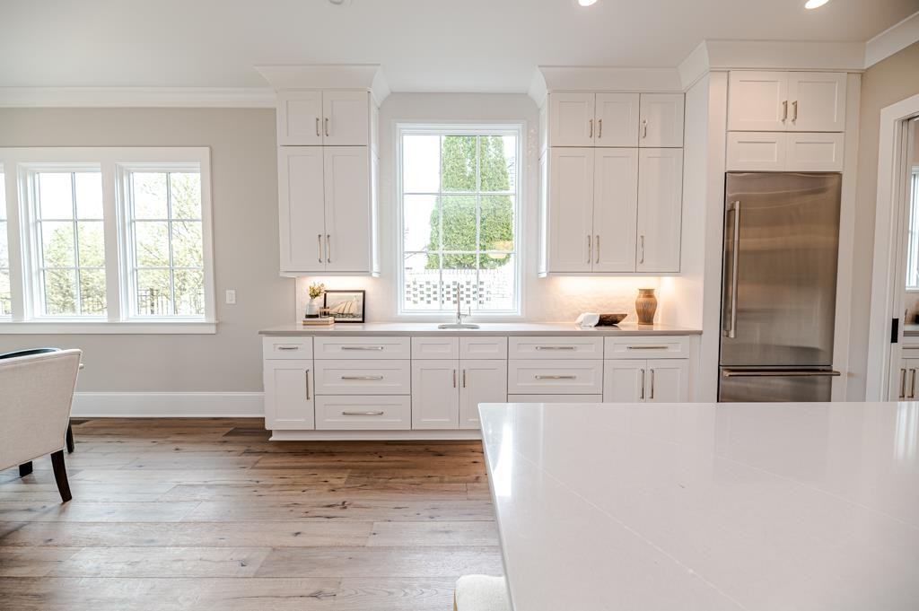 7920 Hardwick Drive Raleigh, NC 27615 - Photo 13 of 53 a kitchen with white cabinets and wooden floors