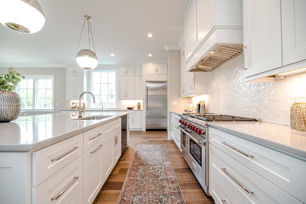 7920 Hardwick Drive Raleigh, NC 27615 - Photo 15 of 53 a large kitchen with stainless steel appliances granite countertop a lot of counter space and a sink
