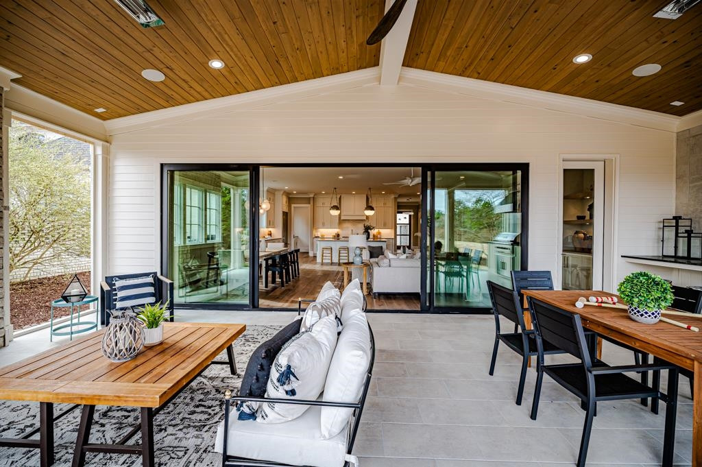 7920 Hardwick Drive Raleigh, NC 27615 - Photo 19 of 53 a living room with furniture a table and chairs next to a window