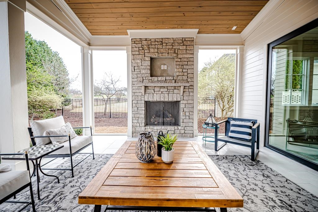 7920 Hardwick Drive Raleigh, NC 27615 - Photo 22 of 53 a living room with patio furniture and a fireplace