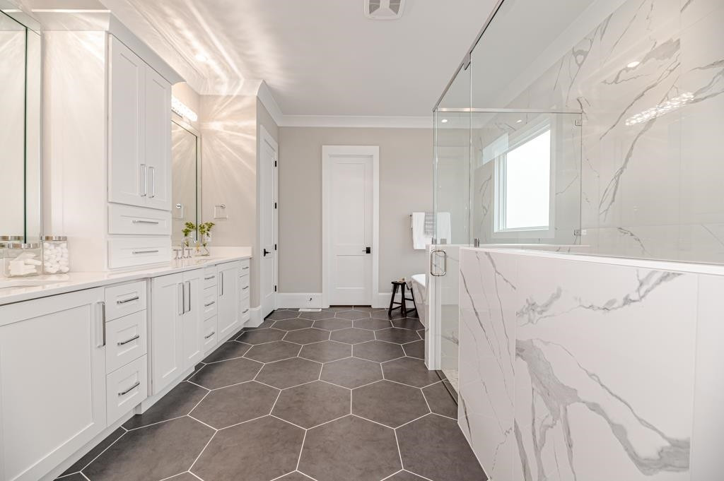 7920 Hardwick Drive Raleigh, NC 27615 - Photo 28 of 53 a spacious bathroom with a double vanity sink a mirror and a shower