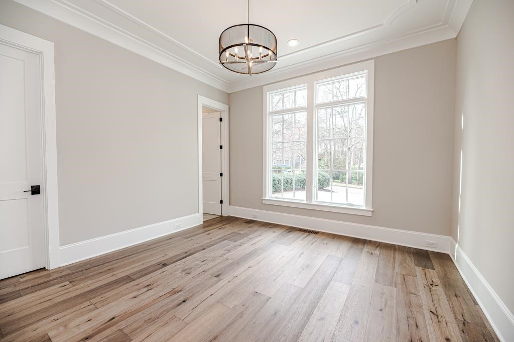 7920 Hardwick Drive Raleigh, NC 27615 - Photo 29 of 53 a view of an empty room with wooden floor and a window