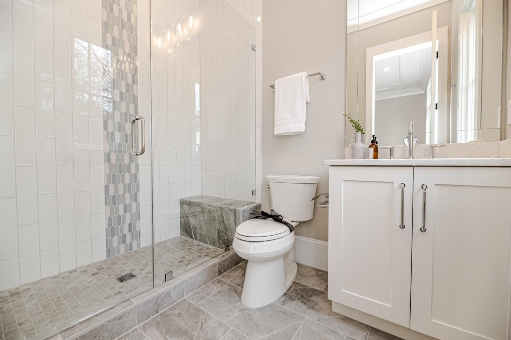 7920 Hardwick Drive Raleigh, NC 27615 - Photo 30 of 53 a bathroom with a sink a toilet and shower