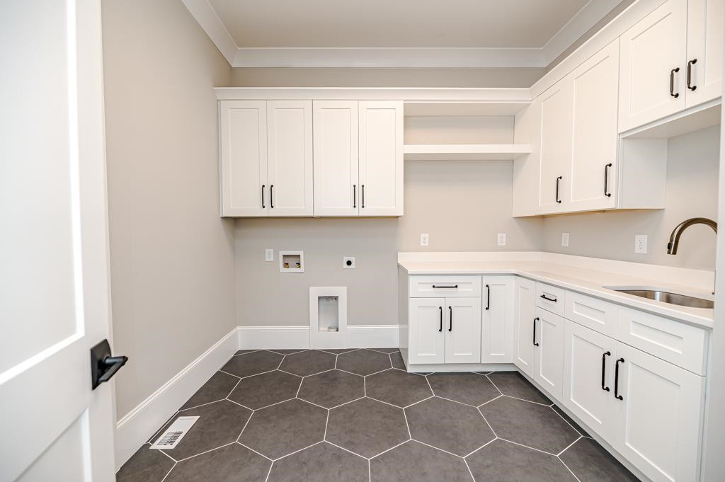 7920 Hardwick Drive Raleigh, NC 27615 - Photo 31 of 53 a kitchen with white cabinets appliances and a window