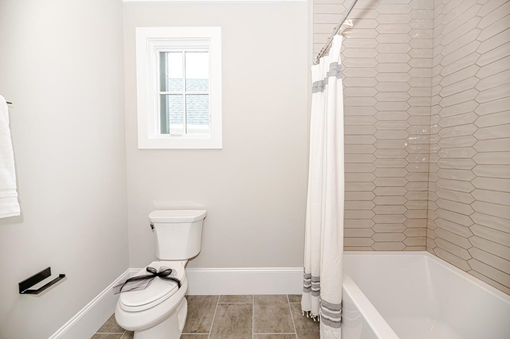 7920 Hardwick Drive Raleigh, NC 27615 - Photo 36 of 53 a bathroom with a toilet and a bathtub