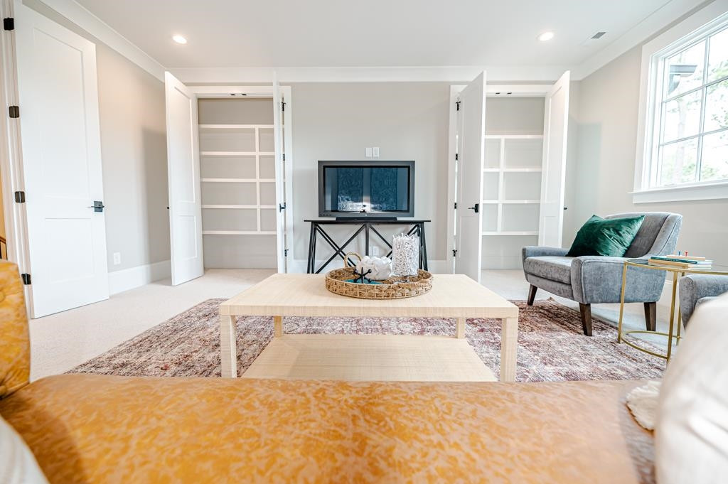 7920 Hardwick Drive Raleigh, NC 27615 - Photo 40 of 53 a living room with furniture and a flat screen tv