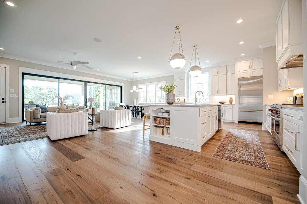 7920 Hardwick Drive Raleigh, NC 27615 - Photo 8 of 53 a large kitchen with cabinets wooden floor and stainless steel appliances