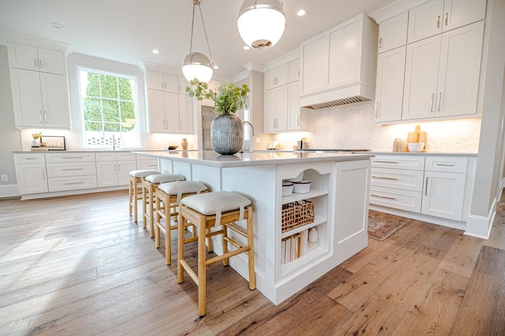 7920 Hardwick Drive Raleigh, NC 27615 - Photo 10 of 53 a kitchen with stainless steel appliances a white table chairs and a white cabinets