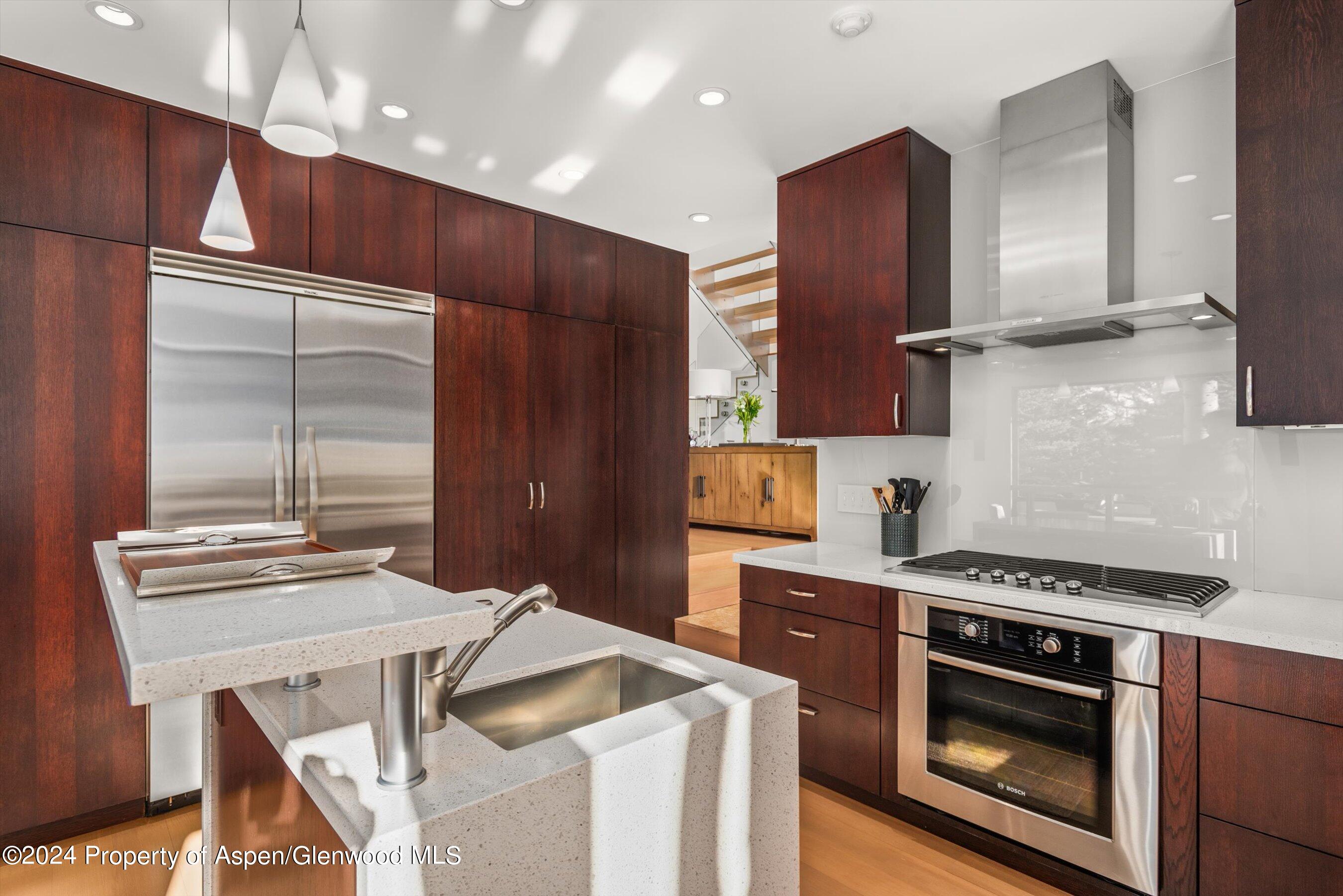 25 Nighthawk Drive Aspen, CO 81611 - Photo 18 of 34 a kitchen with kitchen island stainless steel appliances a stove a sink and a refrigerator