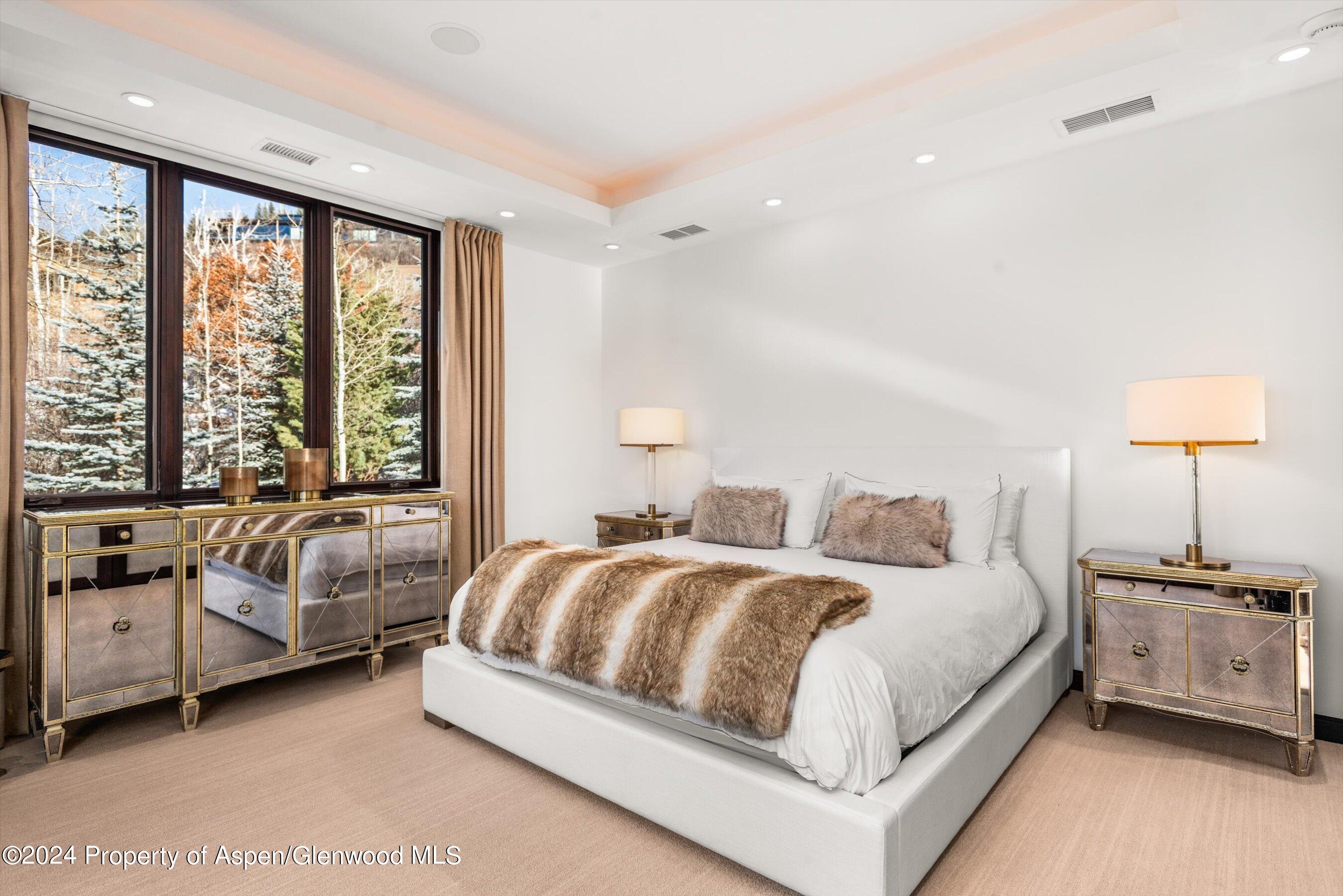 25 Nighthawk Drive Aspen, CO 81611 - Photo 19 of 34 a bedroom with a bed and a couch