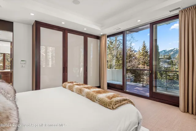 a spacious bathroom with a sink a large mirror and a bathtub