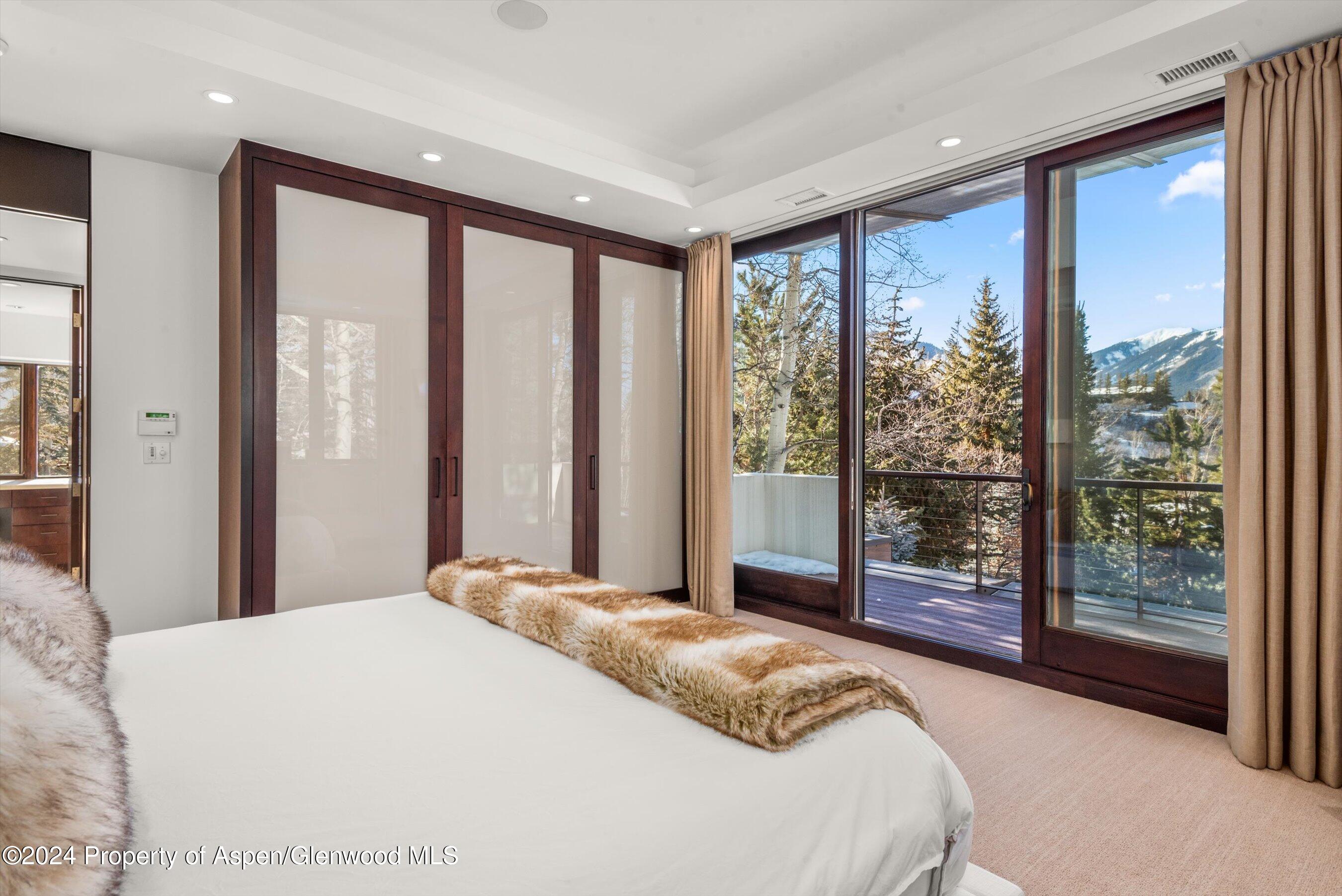 25 Nighthawk Drive Aspen, CO 81611 - Photo 21 of 34 a bedroom with a large window and a bed