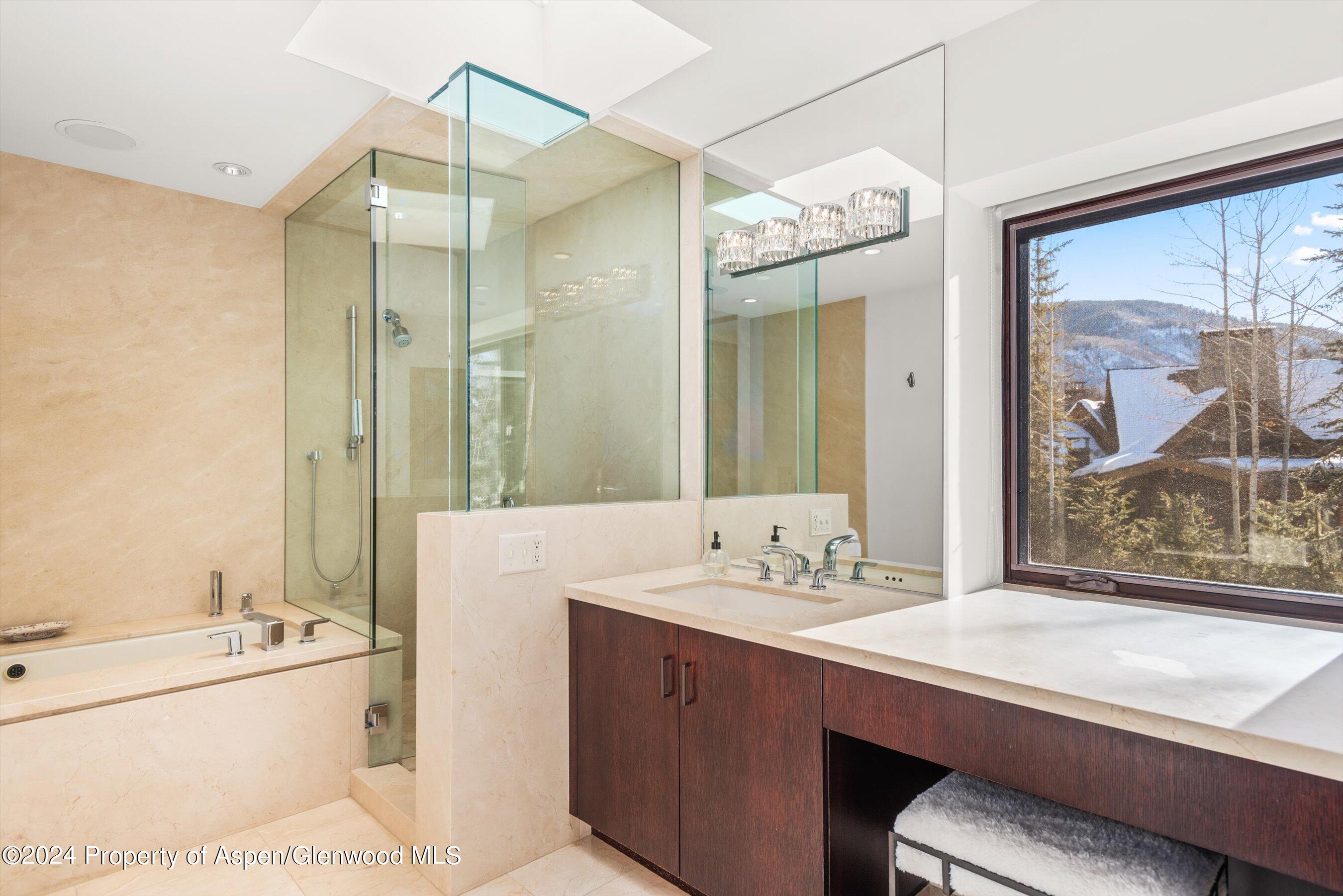 25 Nighthawk Drive Aspen, CO 81611 - Photo 23 of 34 a spacious bathroom with a sink a large mirror and a bathtub