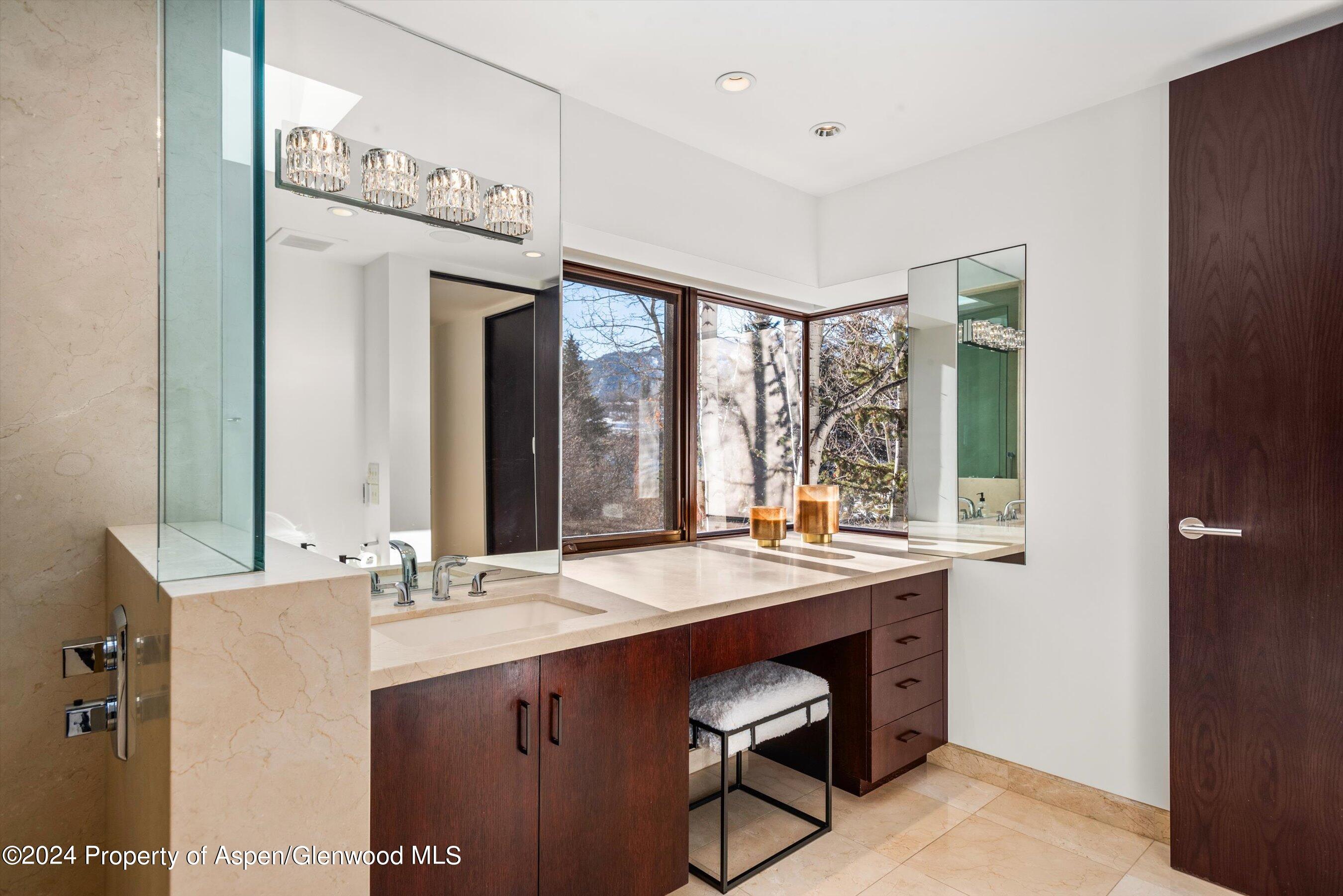 25 Nighthawk Drive Aspen, CO 81611 - Photo 24 of 34 a bathroom with a sink a mirror and a window