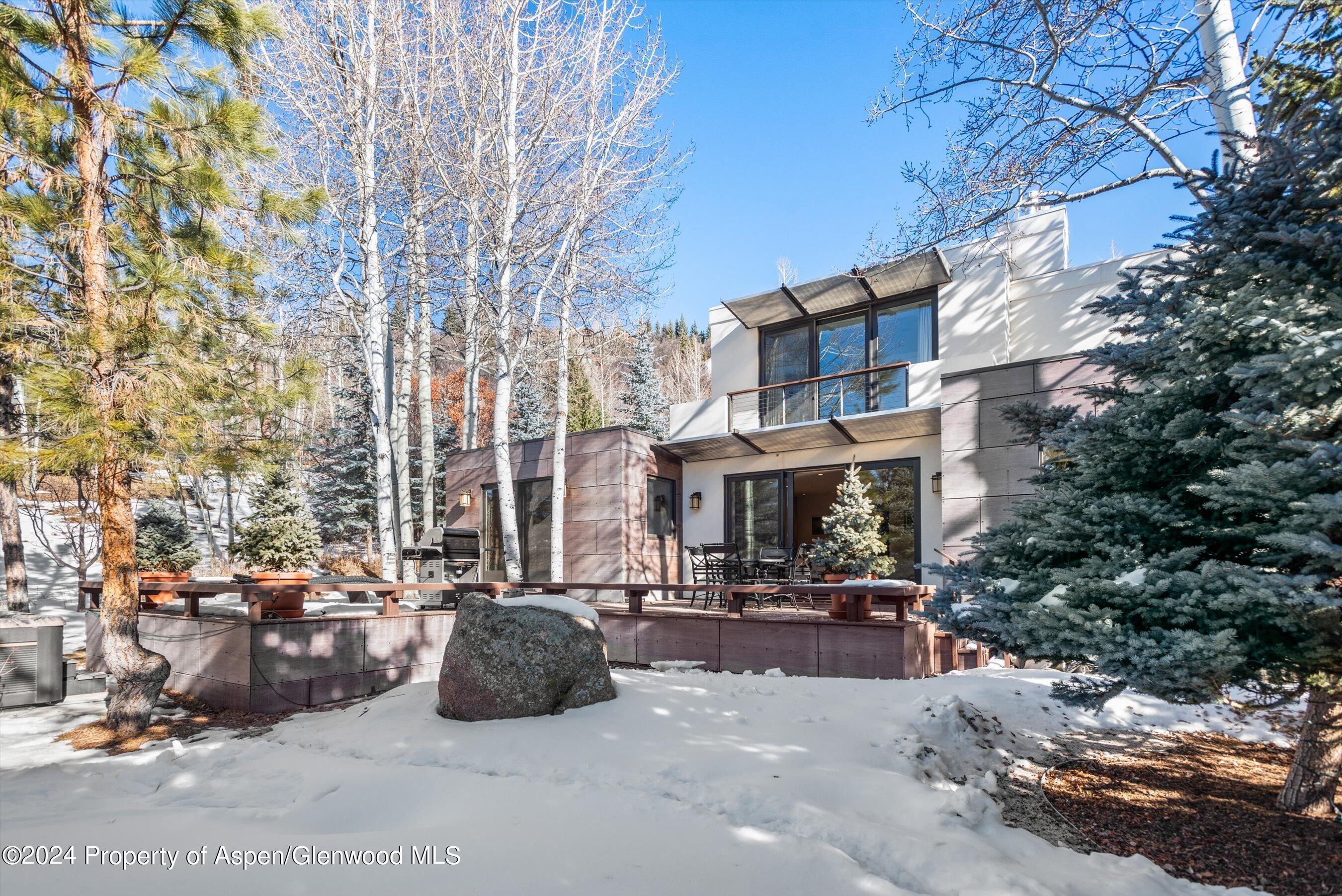 25 Nighthawk Drive Aspen, CO 81611 - Photo 3 of 34 a city view with tall buildings and cars parked on road