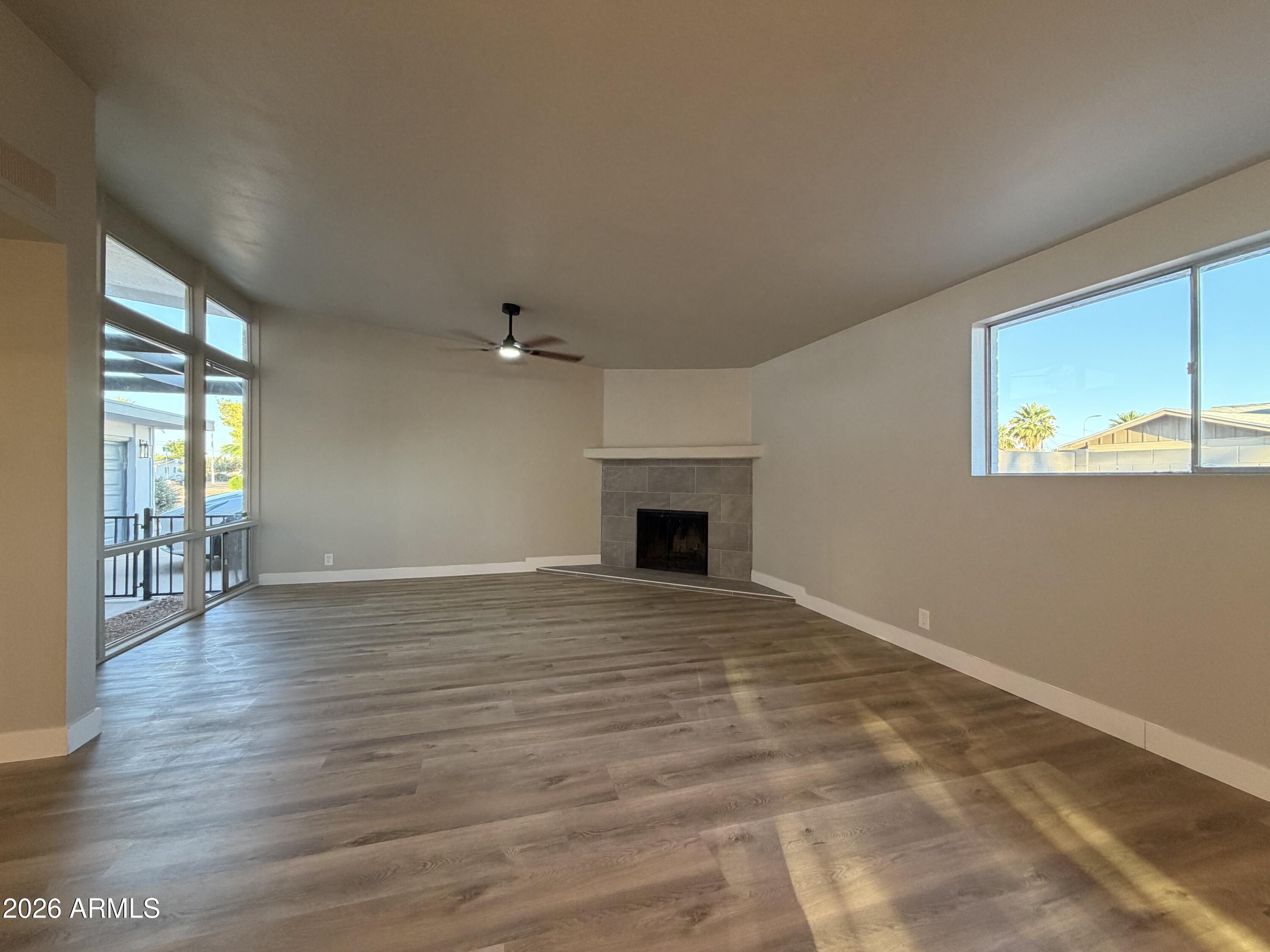 5420 North Granite Reef Road Scottsdale, AZ 85250 - Photo 7 of 30 an empty room with wooden floor and windows