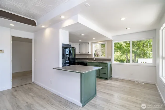 a kitchen with stainless steel appliances granite countertop a stove and a sink