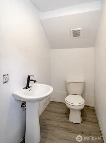 a bathroom with a sink toilet and a mirror