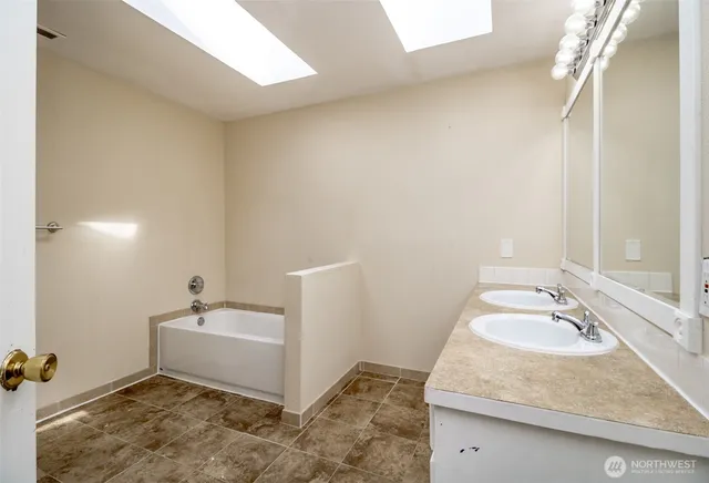 a bathroom with a granite countertop sink and mirror