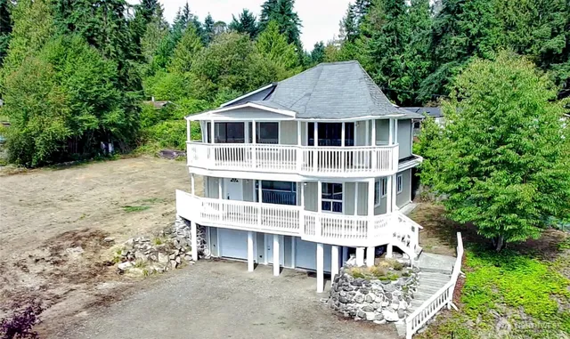 a aerial view of a house with a yard and potted plants