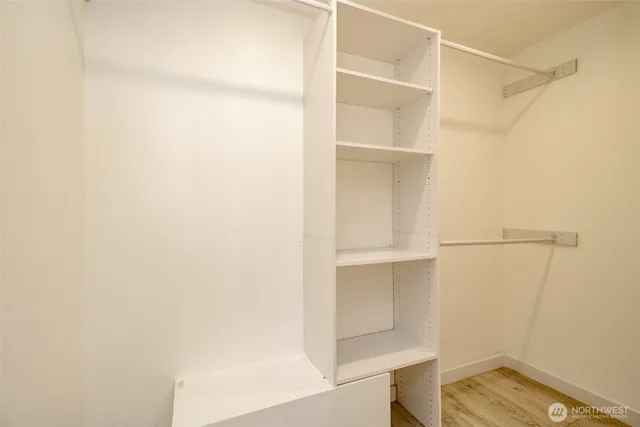 a view of walk in closet with empty racks
