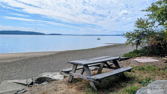 a view of a roof deck with wooden floor and seating space