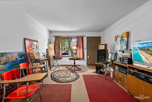 a living room with furniture a rug and a window