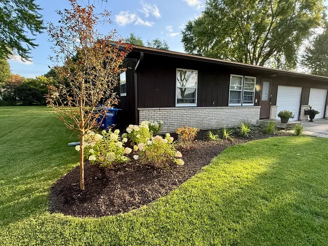 a front view of a house with garden