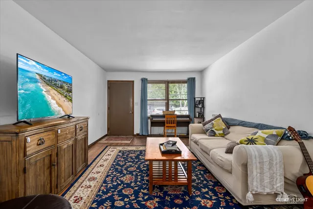a living room with furniture and a rug