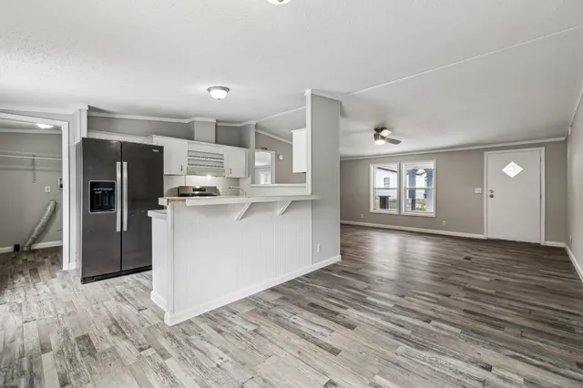 a view of a kitchen with wooden floor and a kitchen