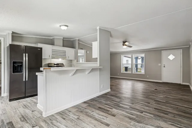 a view of kitchen with refrigerator microwave and wooden floor