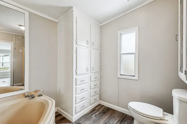 a bathroom with a sink a toilet and shower