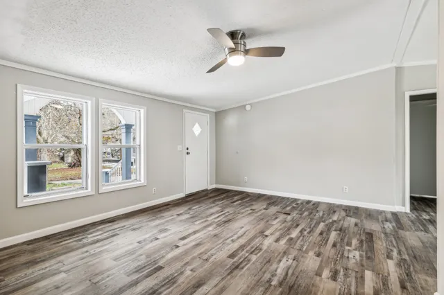 wooden floor in an empty room with a window
